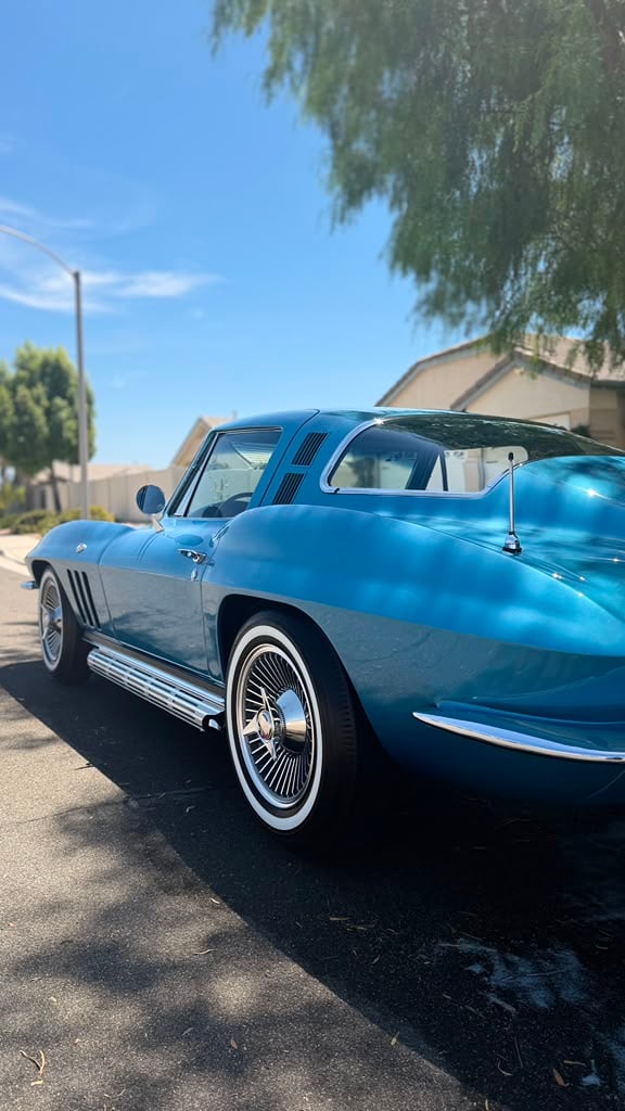 Classic car detailing in Riverside & San Diego County, rear three-quarter view of a classic sports coupe with deep gloss paint and whitewall tires after a full exterior detail