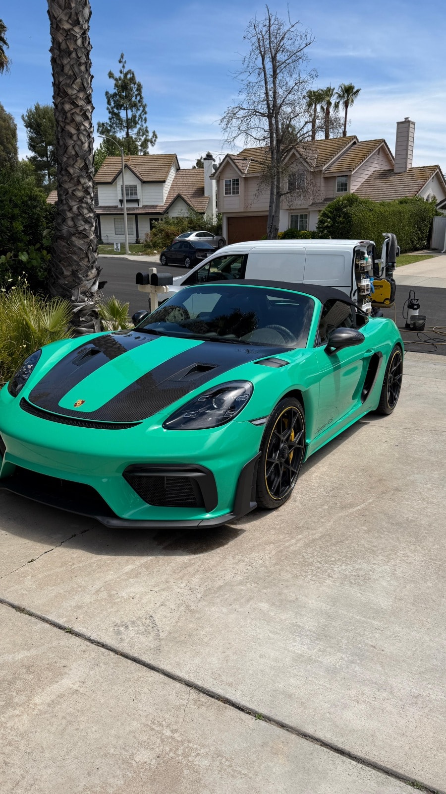 Mobile auto detailing in Riverside & San Diego County — sports car detailed on site with the Royal Rinse van in the background